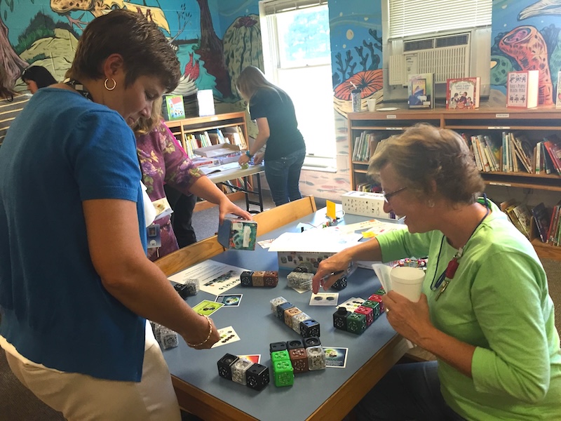 Educators working with K-12 manipulatives at an IMC workshop